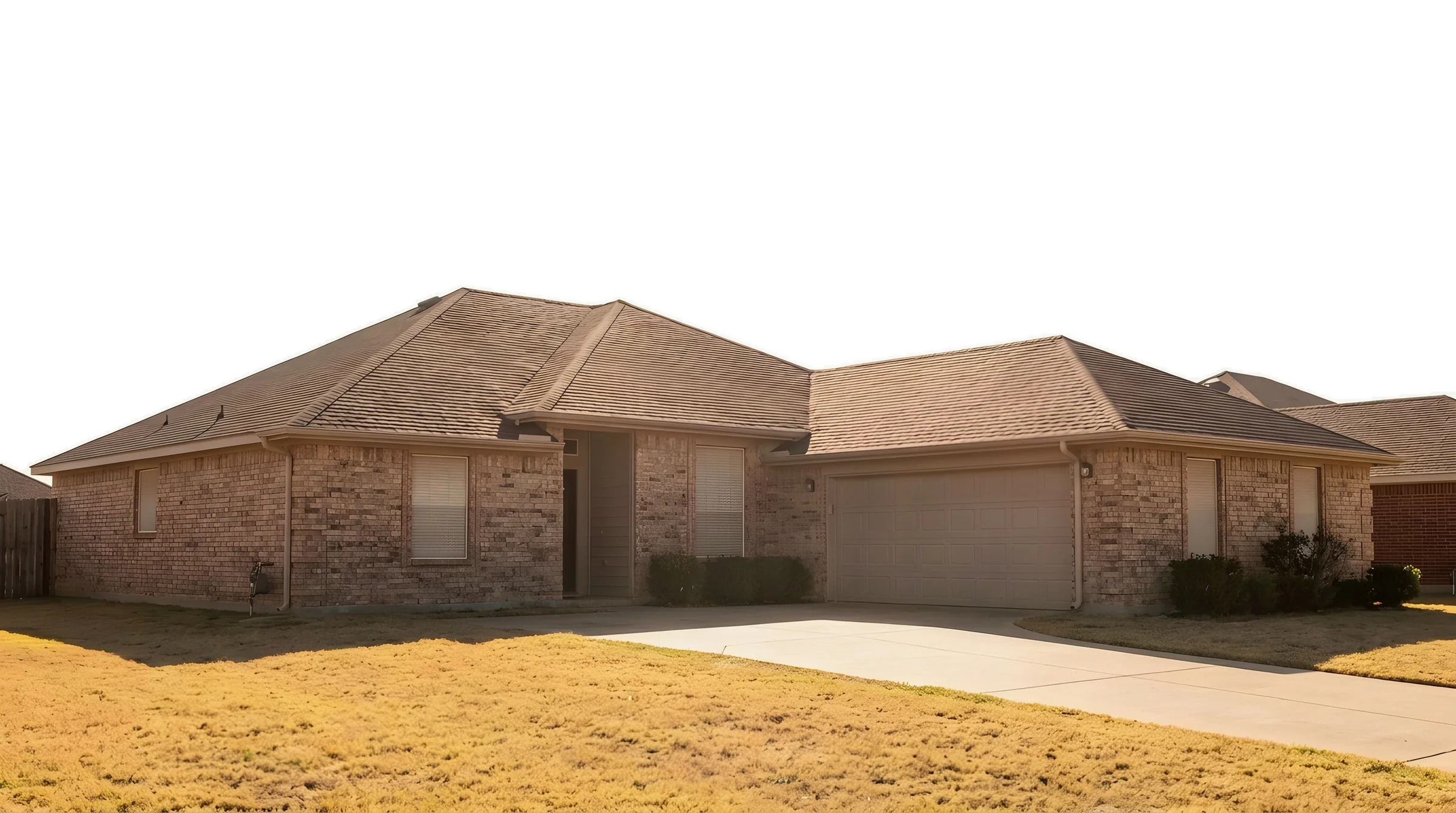 A single-story brick ranch house in Frisco under a hot, bleached afternoon sky, the lawn dried yellow.
